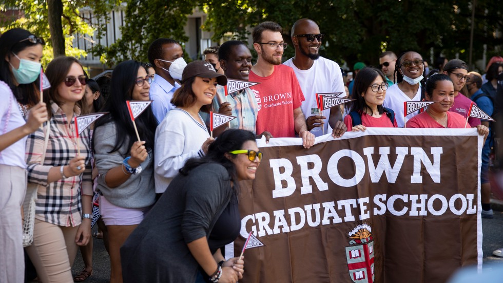 Graduate students with Convocation banner
